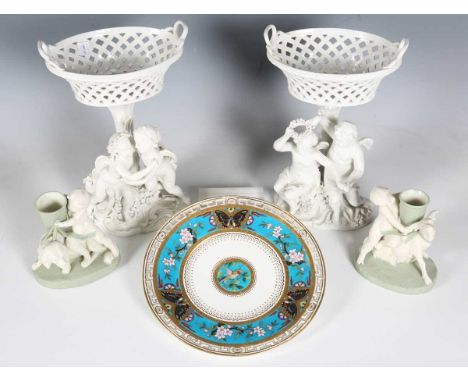 A pair of Meissen style white glazed porcelain centrepieces, late 19th/early 20th century, both modelled with two putti with 
