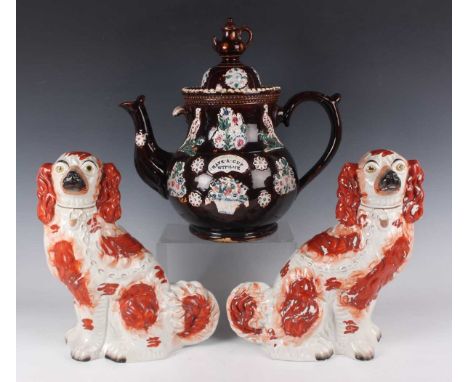A Measham Bargeware teapot and cover, late 19th century, typically brown glazed and sprigged with flowers, fruit and birds ar