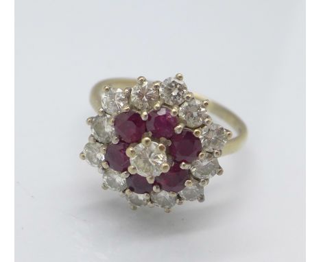 An 18ct gold, diamond and ruby cluster ring, set with thirteen diamonds and six rubies, inside of the shank marked Graff, Gra