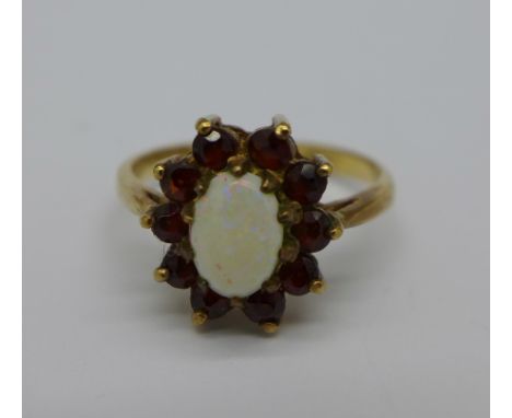 A 9ct gold, garnet and opal ring, 2.1g, L