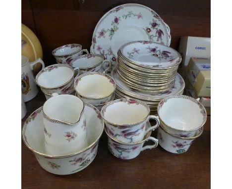 A Melba china tea set, twelve setting with two cake plates, cream and sugar, two cups a/f