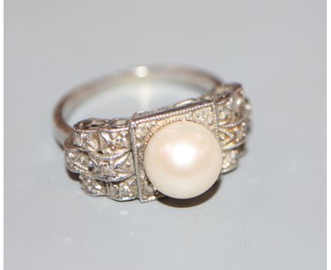 A 1960's? white metal, cultured pearl and diamond chip set dress ring, size K, gross 5.9 grams.CONDITION: Shank has been re-s