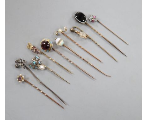 Ten assorted 19th century and later yellow metal and gem set stick pins, including garnet and enamel and banded agate, gross 