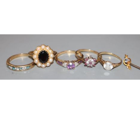 Five assorted modern 9ct gold and gem set dress rings, gross 10.9 grams and a 15ct gem set stick pin, gross 1.2 grams.