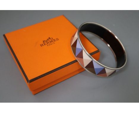 A Hermes, Paris enamelled bangle with geometric pattern, with pouch and box.