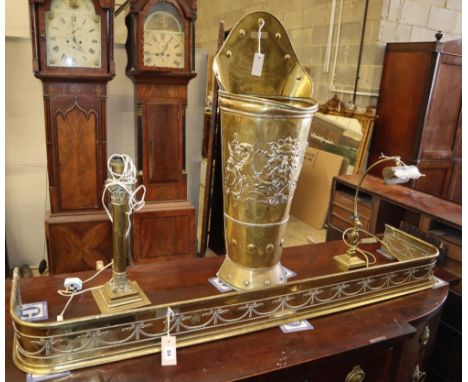 Four brass items, comprising a student's lamp, a table lamp, a 'grape pannier' stick stand and a fender, stick stand H.86cm