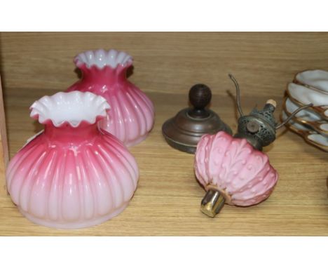 A pair of Victorian oil lamp glass shades, one with reservoir