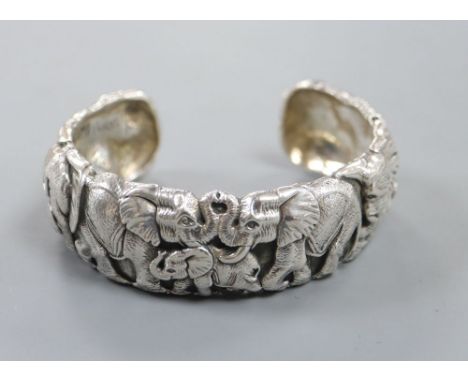 A modern white metal bangle modelled as a heard of elephants by Patrick Mavros, signed and dated 2017, 78mm overall, 99.4 gra