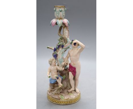 A Meissen 'Bacchus and cherub' candelabrum, 19th century, model no 1190, H. 29cmCONDITION: The tree trunk has been badly re-g