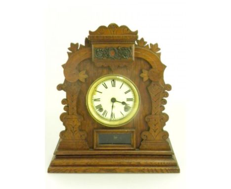 THREE OAK MANTEL CLOCKS, AN OAK MANTEL CLOCK WITH CHIMING MOVEMENT AND A CONTINENTAL STAINED AND CARVED WOOD MANTEL CLOCK