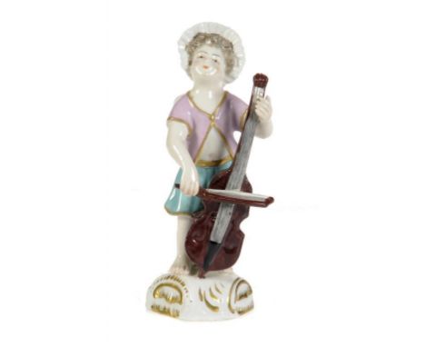 A SAMSON FIGURE OF A MUSICIAN the winged child in bonnet and pink and turquoise costume playing the cello, on gilt base, 10.5