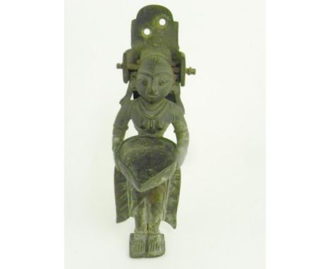 AN INDIAN BRASS MOTIVE STATUETTE OF A DEITY ADAPTED AS A DOOR KNOCKER