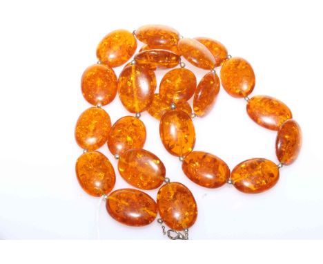 Large amber coloured bead necklace, 93cm; together with a green hardstone hinged bangle