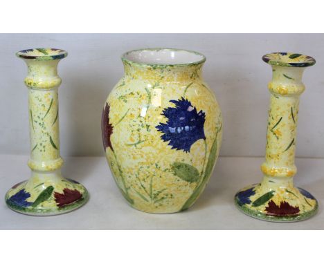 Poole Pottery "Feruccio" pattern vase of baluster form and a pair of matching candlesticks, all 20.5cm high.&nbsp; (3). 