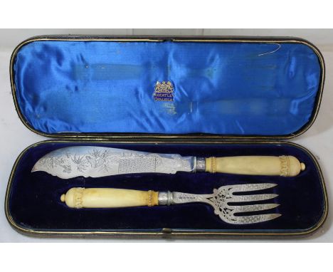 Pair of silver fish servers with ivory handles, the blade and fork with engraved and pierced decoration in the Aesthetic mann