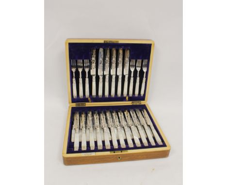 Good set of eighteen silver dessert knives and eighteen forks, engraved, with pearl handles and embossed ferrules, by Henry W