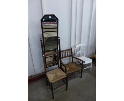 A mahogany cheval mirror, two rush seated chairs and a Victorian painted kitchen chair 
