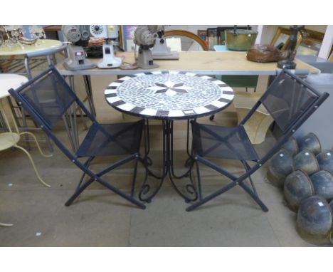 A circular garden table and two chairs 