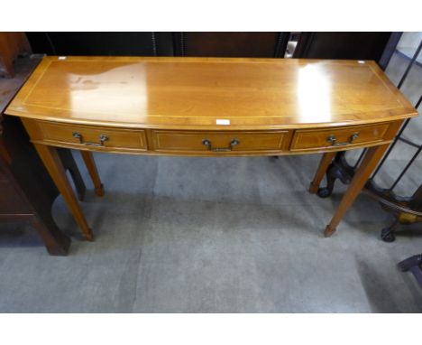 An inlaid walnut three drawer console table 