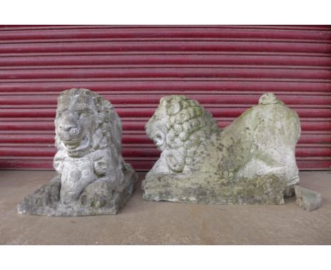 A pair of concrete garden figures of lions capturing rams 