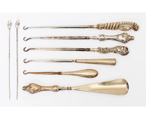 A collection of assorted button hooks, shoe horns, hat pins, etc with silver handles, Victorian and later examples (Q)
