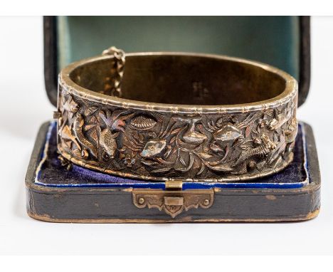 A Chinese white metal bangle, with embossed decoration featuring sea creatures, width approx. 20mm, internal diameter approx.
