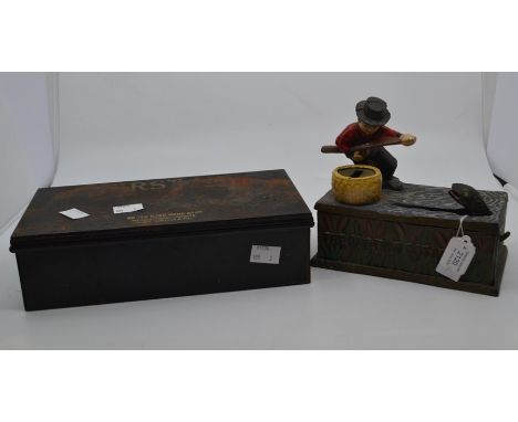A cast iron money box; "The One That Got Away" along with a mid 20th Century first aid tin box