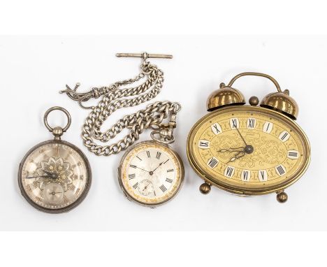 Two Edwardian silver pocket watches along with Albert chain and fob tassel, and a small German alarm clock
