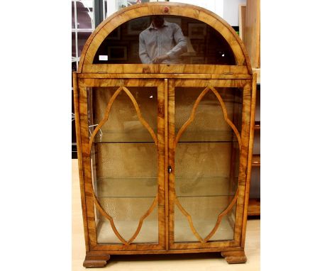 An Art Deco walnut veneered display cabinet, circa 1935, the upper section with a glazed upper section enclosed by a fall fro