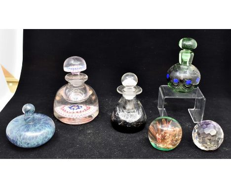 A collection of paperweights, including Caithness glass perfume jars, etcCondition: Damage to stopper on largest perfume bott