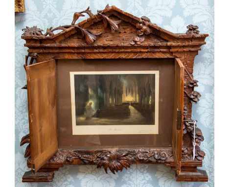 A late 19th Century Black Forest carved wooden wall mounted frame, circa 1880, of architectural form with a pediment, foliage