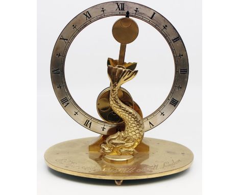 A Dent brass mantle clock, Rd 969702, having a round face, central pendulum, Dolphin brackets, limited edition 296 of 500