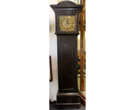 A 20th Century ebonised eight day longcase clock, having a brass dial, three winder holes, the hood with turned columns, the 