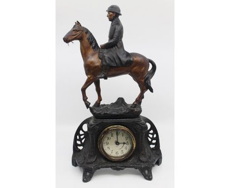 An early 20th Century mantle clock with spelter figure of French soldier on horseback, approx 44 cms high