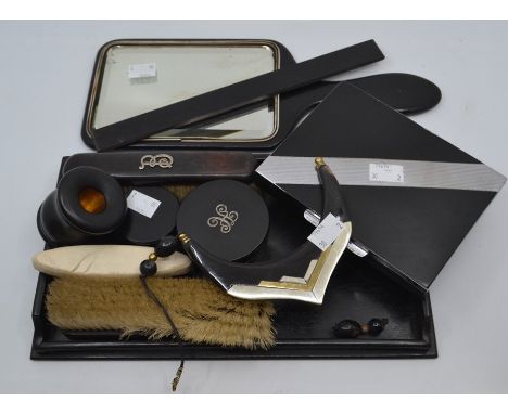 An Art Deco cigarette case; ebony dressing table set, inlaid silver initial, inkwell, mirror and necklet (Q)