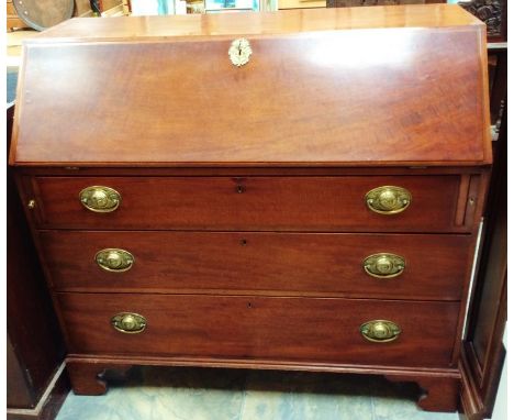 A George III mahogany bureau, circa 1800, the fall front opening to reveal a fitted interior, with a central cupboard, drawer