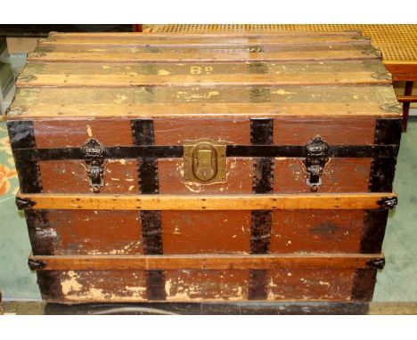 A late 19th Century Dome topped wooden trunk, the lid opening to reveal removable shelf, 64cm high, 92cm wide, 54cm deep