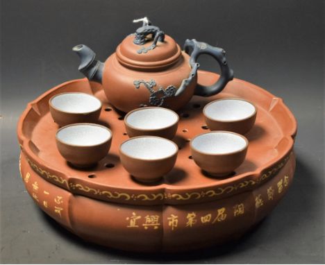 A Chinese clay/terracotta tea set, comprising teapot, six tea bowls and basin
