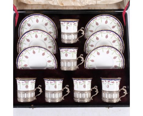 Edwardian Royal Worcester set of coffee cups in silver holders (Birmingham 1907 hallmarks) and saucers, with swag and ribbon 