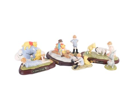 A group of Royal Doulton Christopher Robin Winnie The Pooh figures, including Going Sledging on separate plinth, L21cm, and a