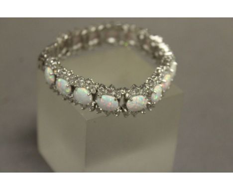 An impressive silver CZ and opal line bracelet