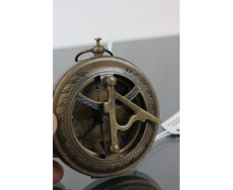 A brass cased compass and sundial