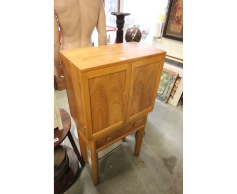 A Heals style light oak and pine cabinet with single drawer below raised on chamfered legs.