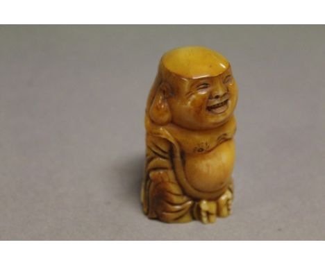 Bone netsuke of a Happy Buddha