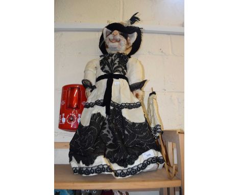 A large model of a cat in Victorian dress