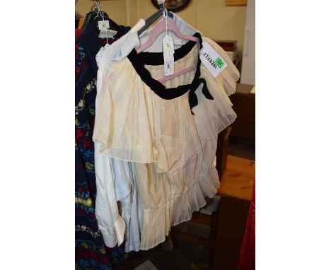 Three mid 20th century lady's blouses, to include a cream silk blouse, a pale blue silk blouse with breast pockets and pintuc