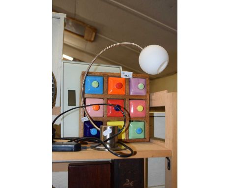 A modern spice chest and a small table lamp
