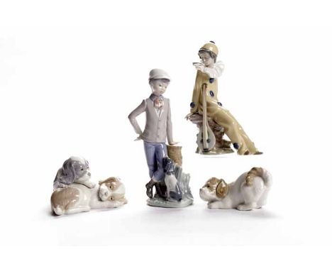 GROUP OF FOUR NAO FIGURES
including one modelled as a seated clown, a young boy with a puppy, a group of two spaniel puppies 