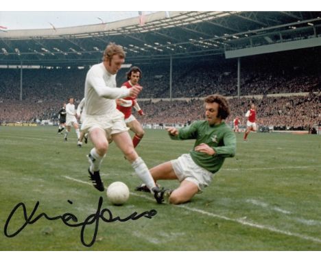 Autographed Mick Jones 8 X 6 Photo: Col, Depicting Leeds United Centre Forward Mick Jones Being Confronted By Arsenal Goalkee