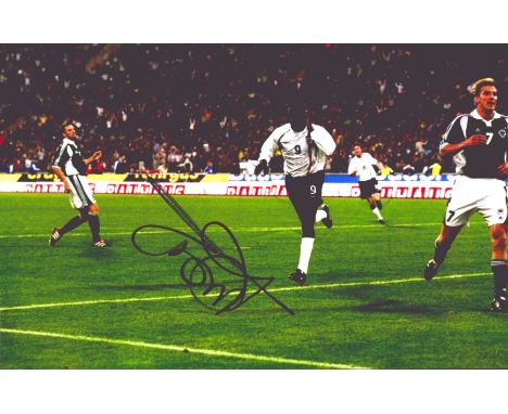 Football Emile Heskey signed England v Germany 12x8 colour photo. Emile William Ivanhoe Heskey (born 11 January 1978) is an E